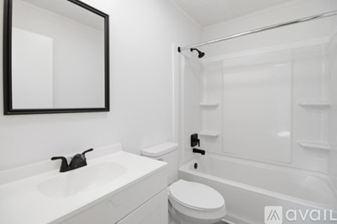 A bathroom with a white sink, toilet and bathtub.