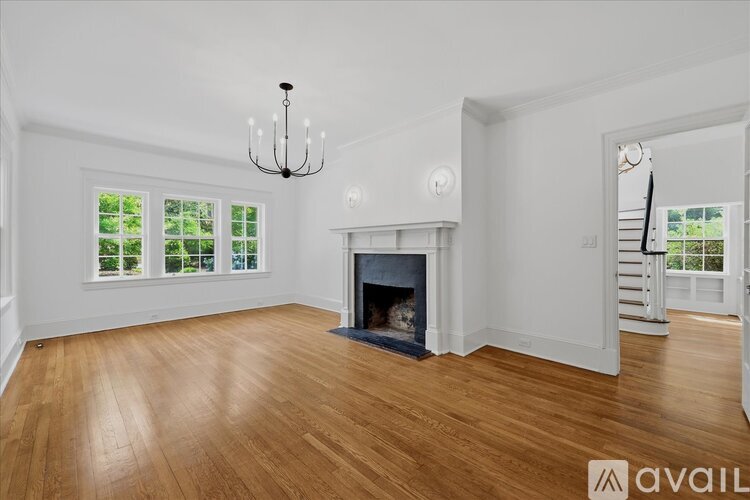 A living room with a fireplace and a chandelier.