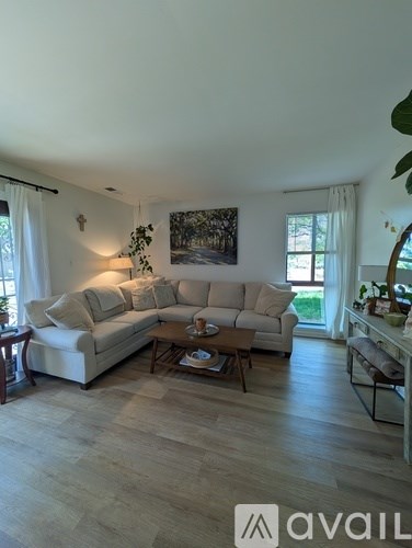 A living room with a large couch and a coffee table.