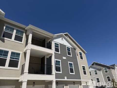 A row of modern apartment buildings with balconies and multiple windows.
