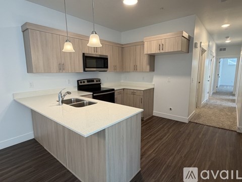 A kitchen with a white countertop and wooden cabinets.
