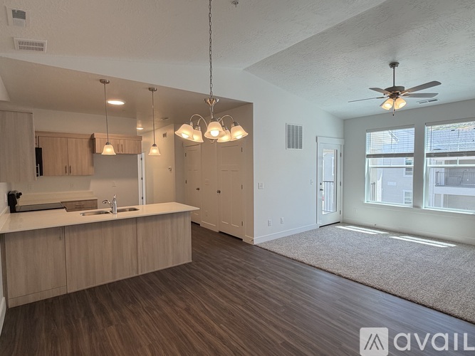 A spacious kitchen with wooden floors and a large island.