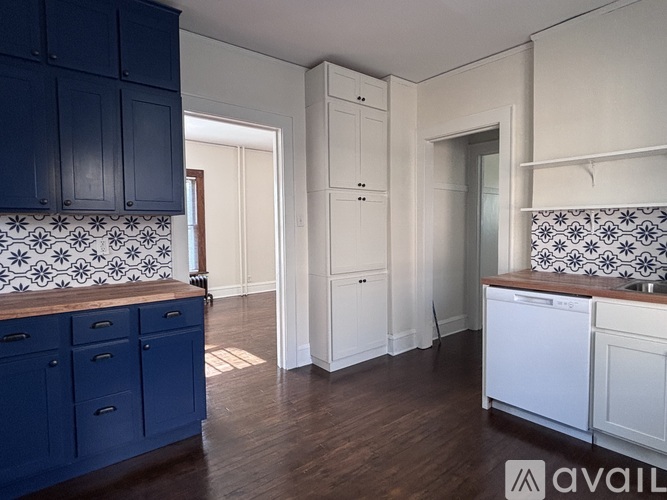 A kitchen with blue cabinets and white appliances.