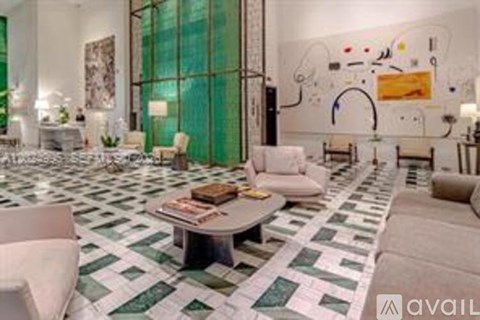 A living room with a green and white tiled floor and a large abstract painting on the wall.