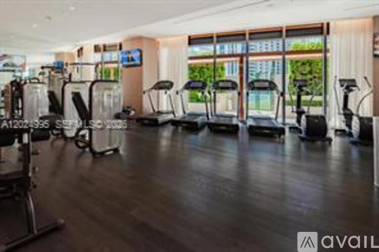A gym with treadmills and elliptical machines.