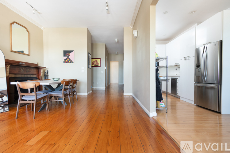 A kitchen with a dining table and chairs.
