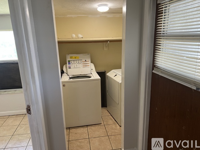 A small laundry room with a washer and dryer.