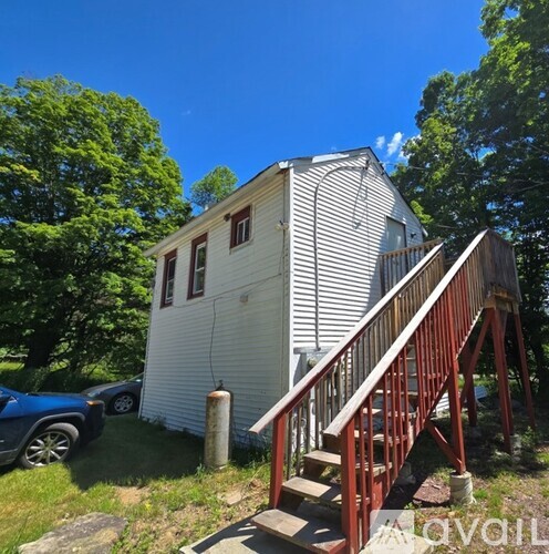 A house with a red staircase leading to the front door.