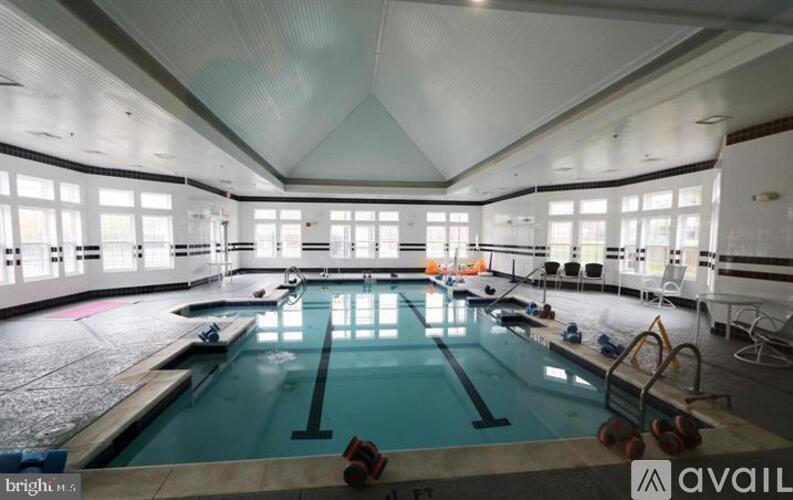 A large indoor swimming pool with lane dividers and a starting block.