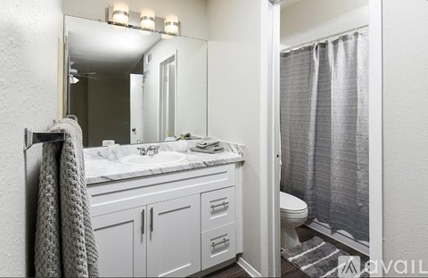 A bathroom with a white sink and a mirror above it.