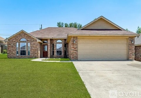 A house with a garage and a driveway in front.