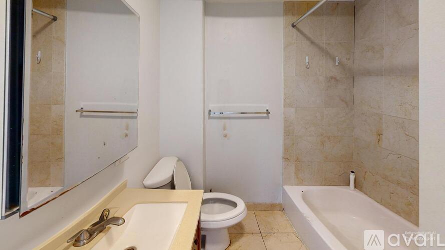 A bathroom with a sink, toilet, and bathtub.
