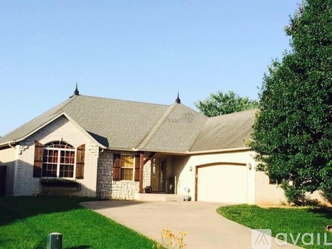 A house with a garage and a driveway is for sale.