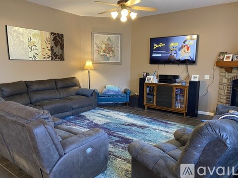 A living room with a television playing cartoons on a black screen.