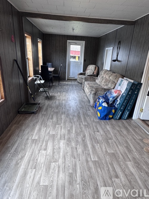 A living room with a grey floor and furniture.