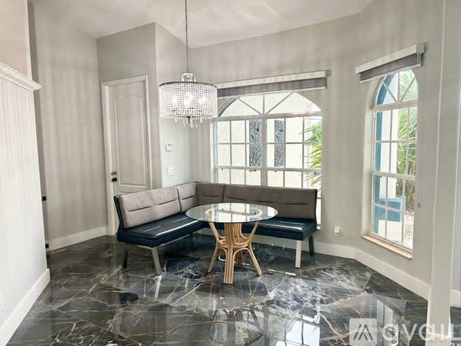 A dining area with a round table and bench seating.