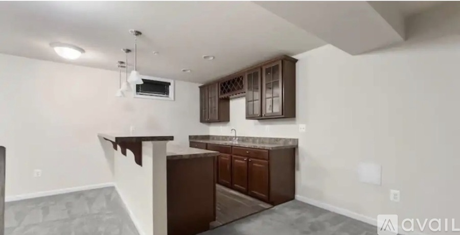 A kitchen with brown cabinets and a countertop is shown.