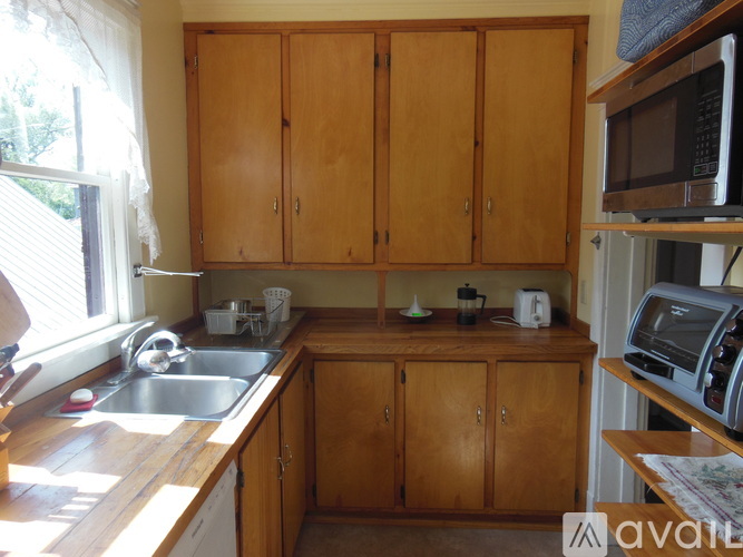 A kitchen with wooden cabinets and a sink.
