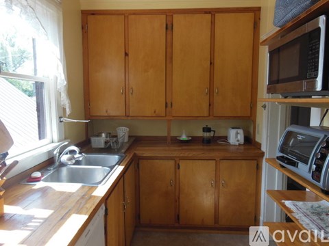 A kitchen with wooden cabinets and a sink.