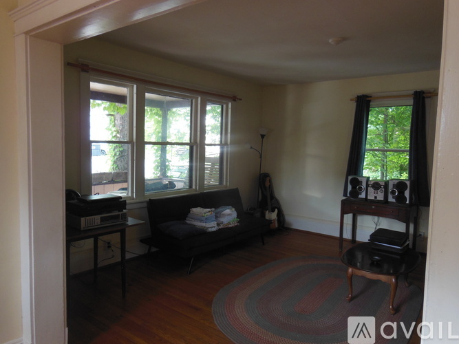 A living room with a couch, chair, and window.
