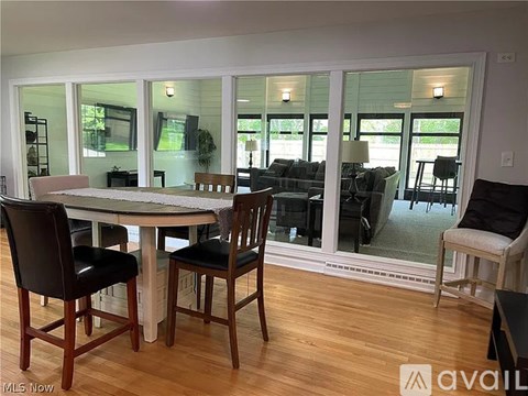 A dining room with a table and chairs.