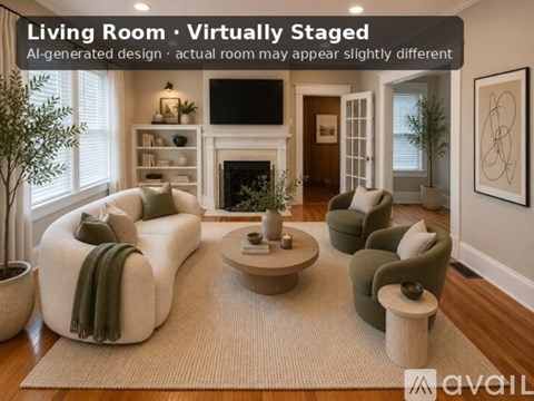 A living room with a white sofa and green armchairs.
