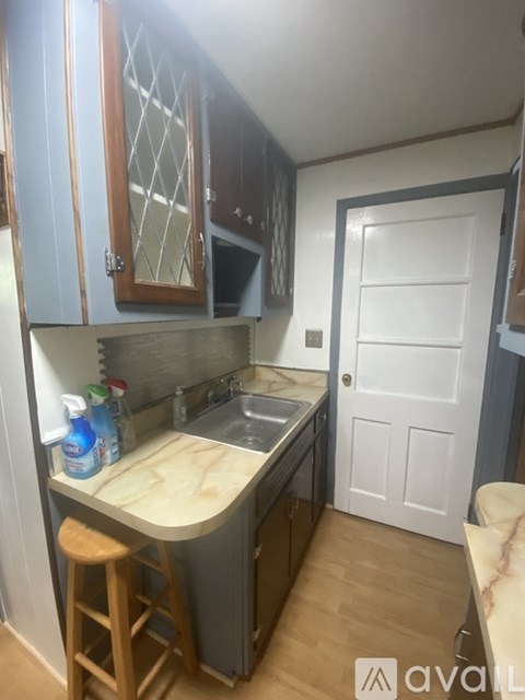 A kitchen with wooden cabinets and a white door.