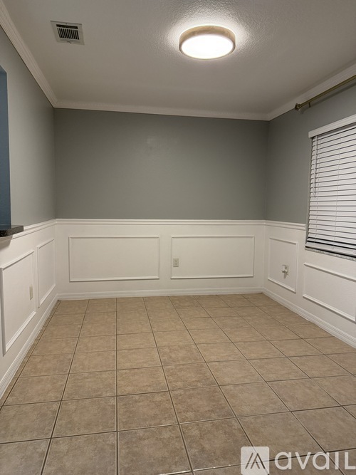 A room with a tiled floor and white trim.