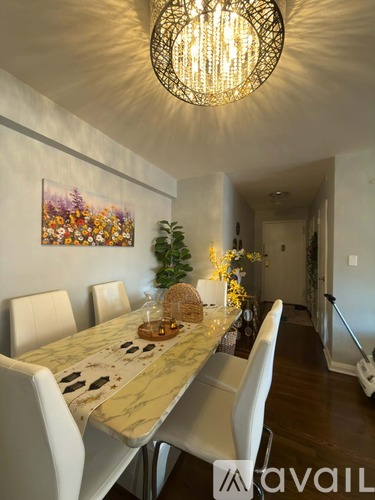 A dining room with a long table and chairs.