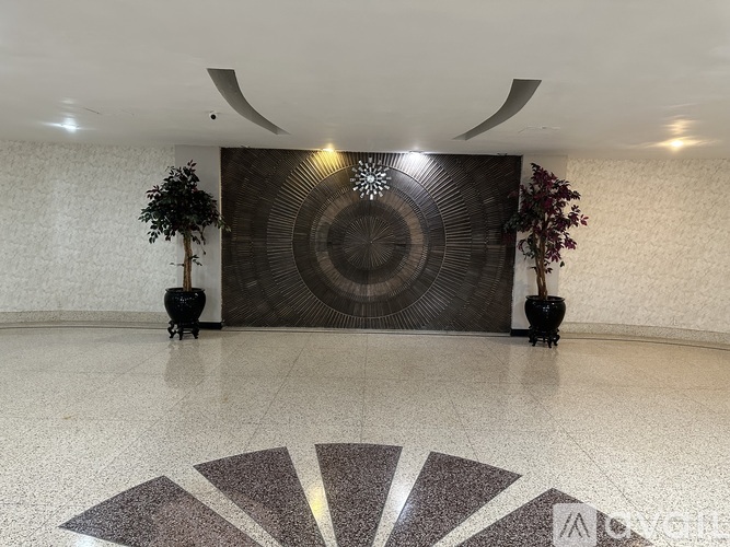 A large circular artwork is the focal point of this spacious room.