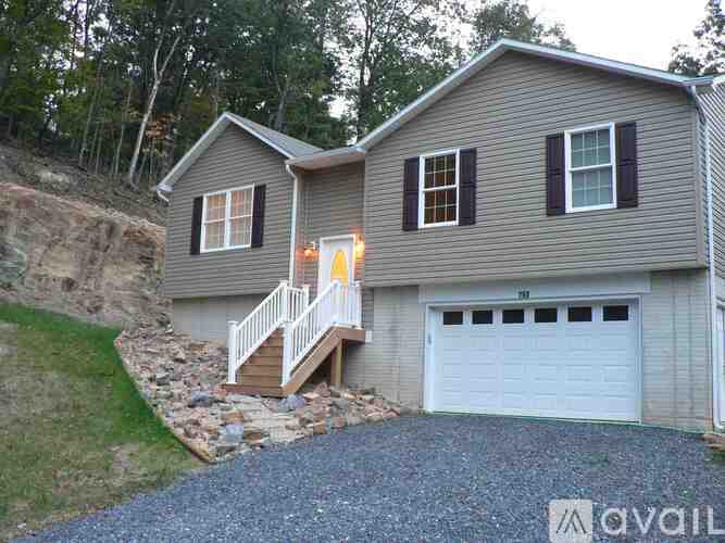 A house with a garage and a deck is for sale.
