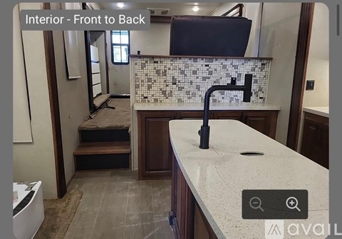 A kitchen with a sink and a window.