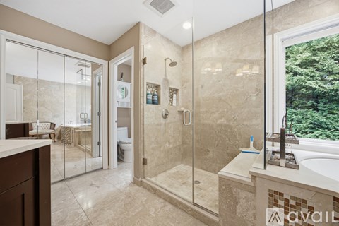 A bathroom with a walk-in shower and a tub.