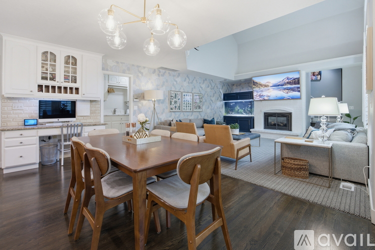 A modern kitchen with a dining table and chairs.