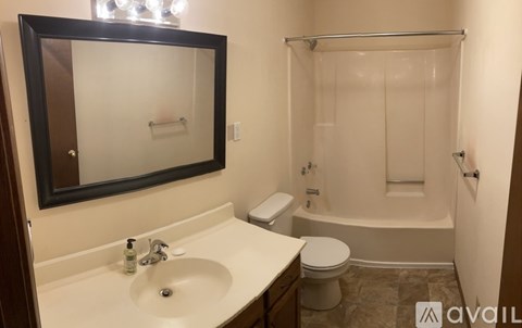 A bathroom with a sink, toilet, and bathtub.
