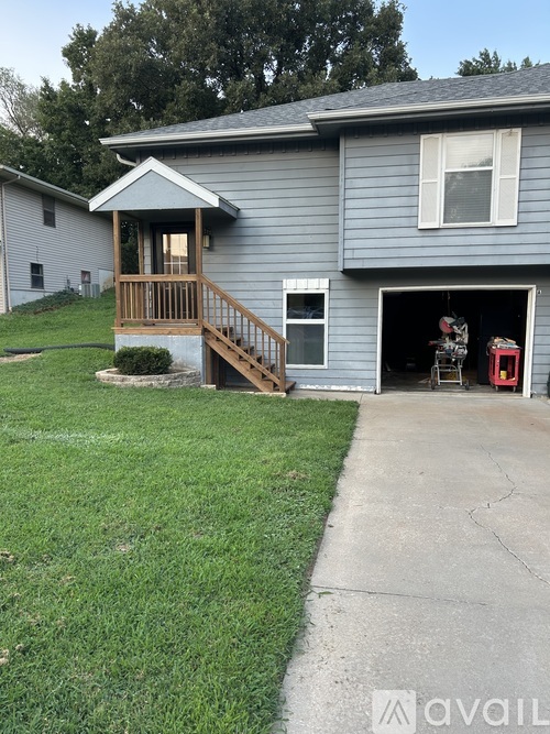 A house with a garage and a porch.
