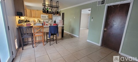 A kitchen with a dining table and chairs.