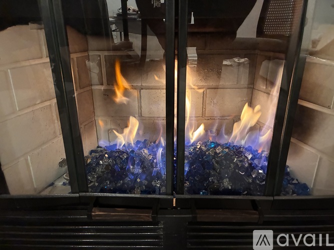 A fireplace with a fire burning inside.