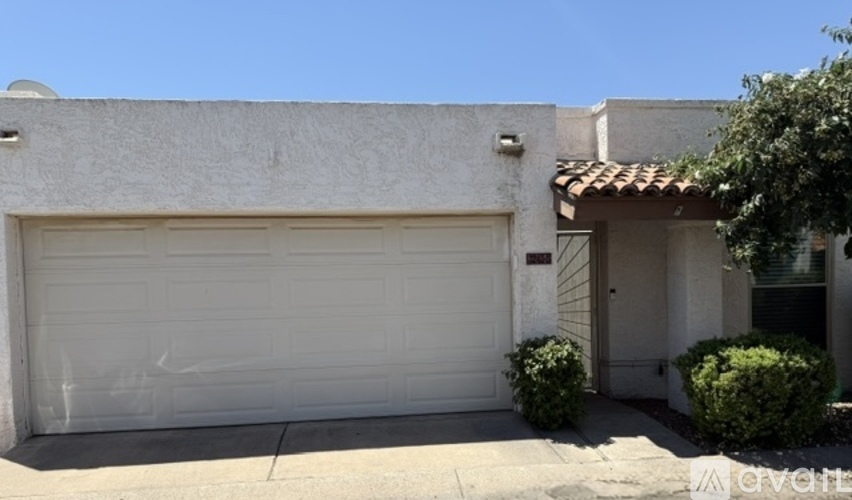 A white garage door is closed.