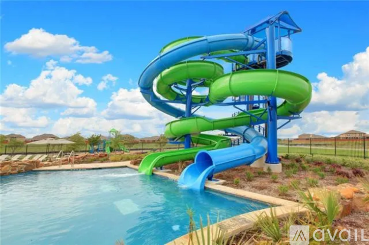A blue and green water slide in a pool.