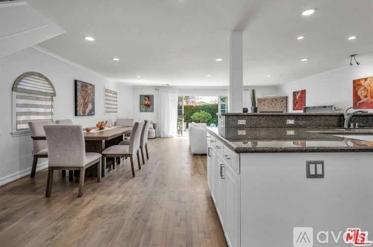 A modern kitchen with a dining table and chairs.