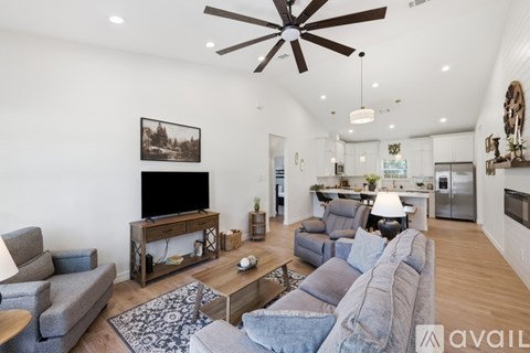 A living room with a grey couch and a wooden coffee table.