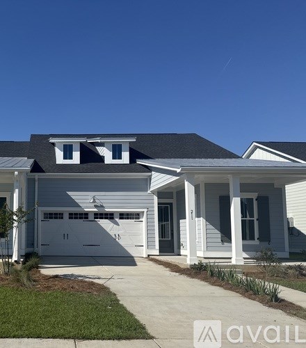 A two-story house with a garage and a front porch.