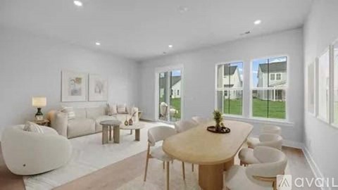 A modern living room with a large table and chairs.