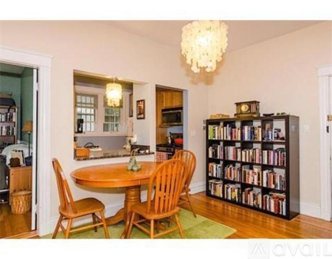 A living room with a dining table and chairs.