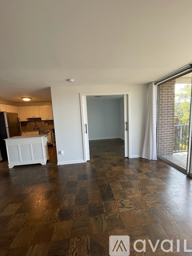 A room with wooden flooring and a white cabinet.
