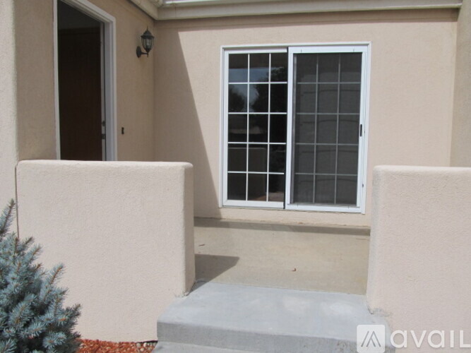 A small patio with a window and a door.
