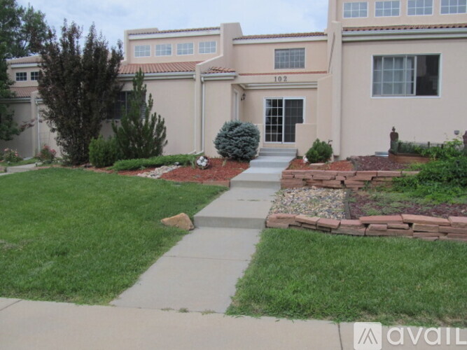 A house with a front yard and a sidewalk leading to the front door.