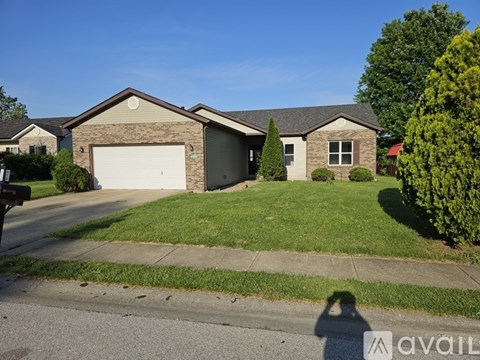 A house with a garage is for sale.