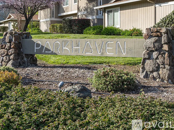 A stone sign that says Parkhaven in front of a building.